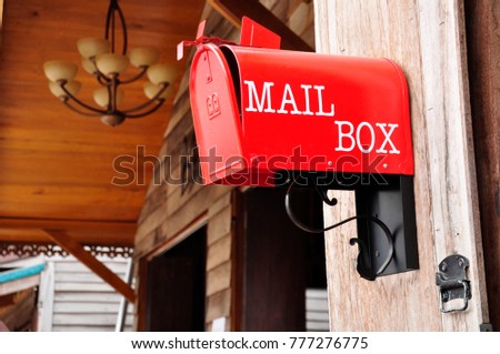 Old red mailbox still usable. Royalty-Free Stock Photo #777276775