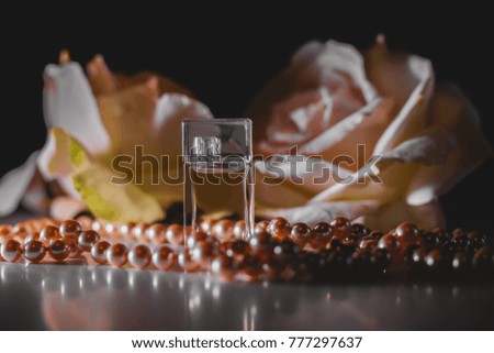 Perfume bottle with flowers and pearls