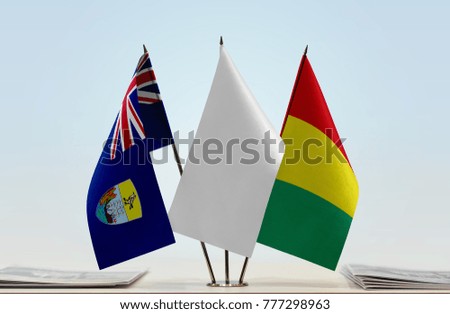 Flags of Saint Helena and Guinea with a white flag in the middle