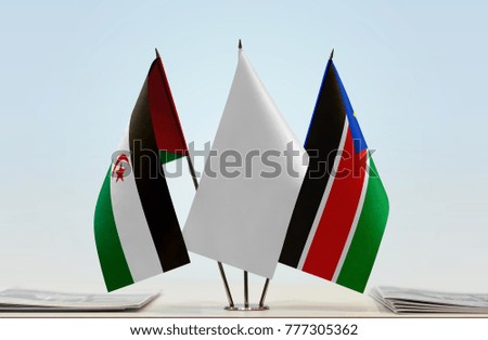 Flags of Sahrawi Arab Democratic Republic and South Sudan with a white flag in the middle
