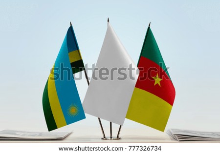 Flags of Rwanda and Cameroon with a white flag in the middle