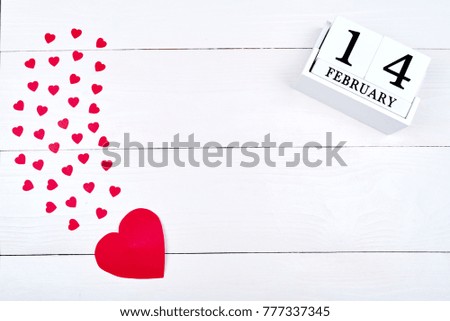 White wooden Valentines Day background with paper red hearts and wooden block calendar, copy space. Greeting card mockup for Saint Valentines Day. Symbol of love. Love concept, Top view, flat lay