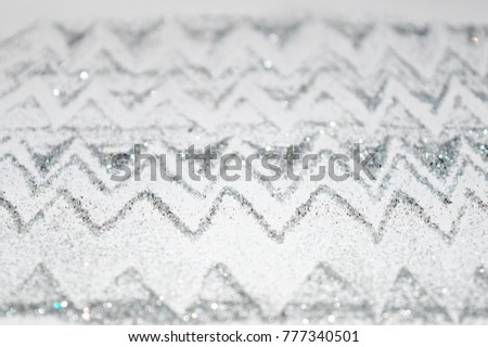 Abstract blurry wavy background of silver glitter sparkles, decorative sequins for your design