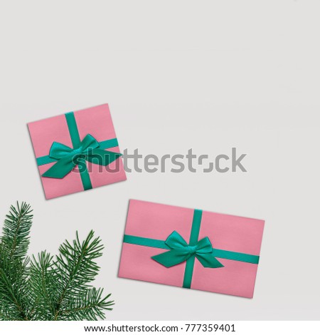 Gift boxes Flat lay Trendy styled photo Two stylish pink gift boxes with colorful turquoise ribbons and spruce branch on white background Photo mockup with space for text Top view