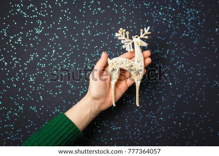 Christmas decorations on the hands, flat lay on a starry background, holiday greetings