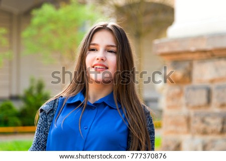 Portrait of a beautiful teenage girl in park. Close up photo