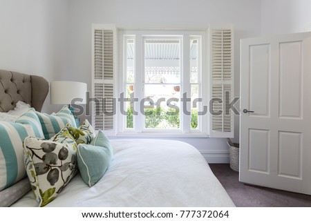 Bedroom window with a garden view in a luxury country house bedroom Royalty-Free Stock Photo #777372064