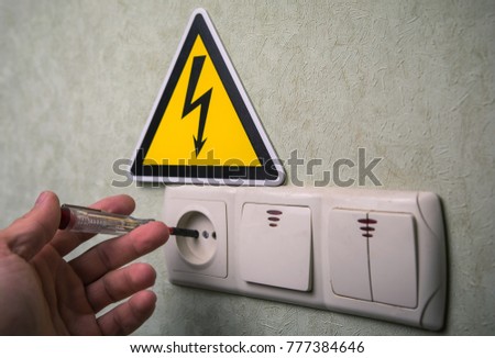 The electrician makes electrical measurements; jumps tension, electrical safety.