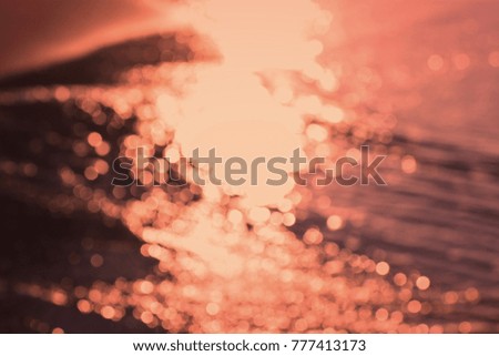 the golden light blurred bokeh abstract backgrounds from sunlight on the sea beach sand