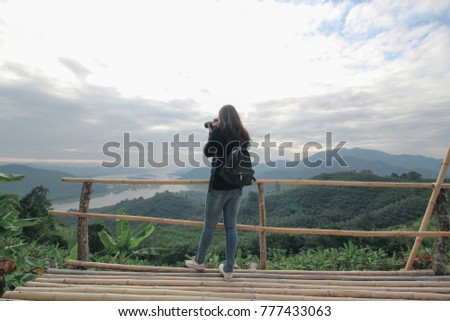 Beautiful Nature Landscape of thailand : Travel camera woman in black look and take picture landscape of Mekong River from the top the Phu Huay Isan Sangkhom Nong Khai, Thailand,Landscape hdr style.