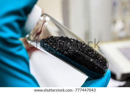 activated carbon or granular in clear bottle is used in air purification, decaffeinate, gold purification, metal extraction, water purification, medicine, sewage treatment, air filters in gas masks Royalty-Free Stock Photo #777447043