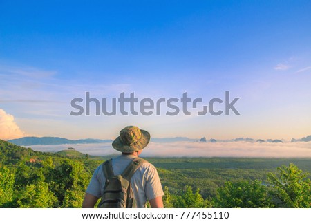 Men's Travel adventure, backpacking . Morning light tour with mountains near the sea, Samed Nang Chee viewpoint tropical zone in Phang Nga Thailand.