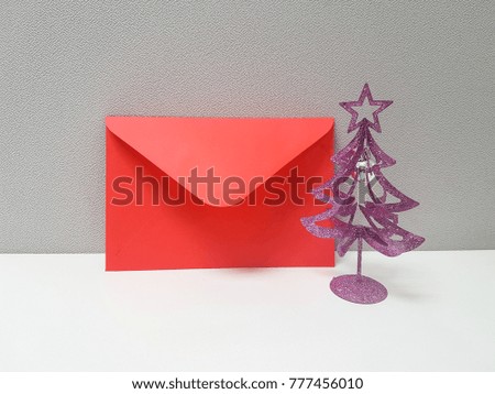 Red envelope that decorate with little Christmas tree. Sending love and good word for Christmas. Christmas cards. Sign and symbol concept.