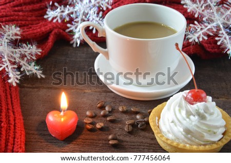 cup of coffee with grains, red burgundy scarf, wooden, winter concept, hot drink, snowflake cap cake, gift box, valentine's day, heart shape symbol on wooden background