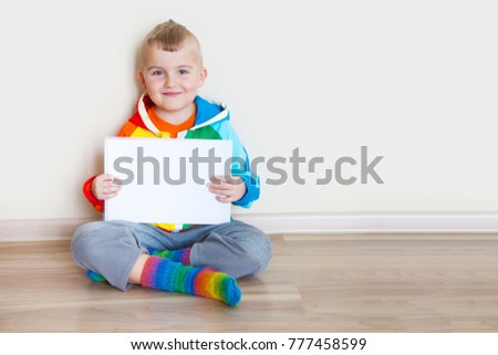 The boy holds an album with a blank page for inscription or text