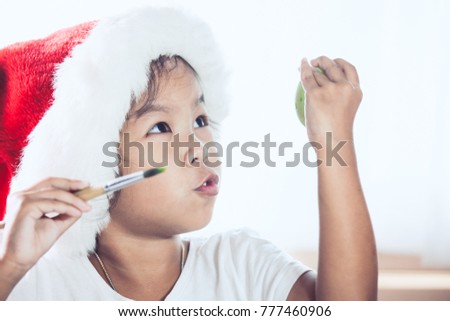 Happy asian child girl drawing and painting on easter egg prepare for easter day