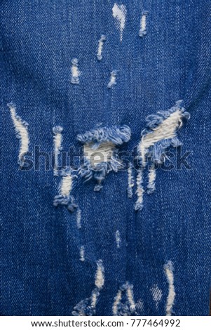 blue torn jeans texture close up
