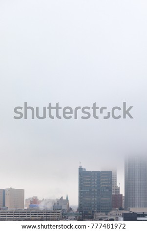 Close up of downtown buildings shrouded in fog