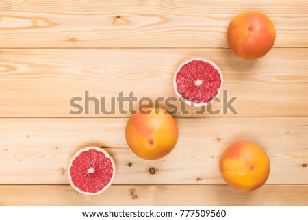concept of grapefruits in the corner of a wooden background