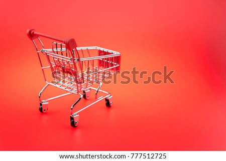 A Shopping Cart On red background, isolated shopping cart on the red