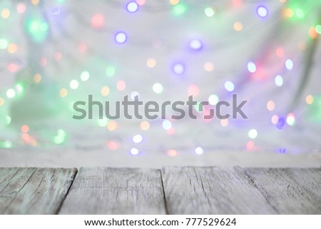 Empty wooden table or shelf wall on colorful bokeh background. For present your products.