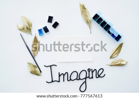 Photo of artcomposition with white paper brushes and paints