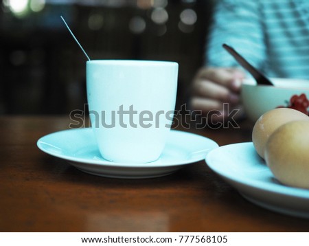 Coffee mug with newspaper on teal rustic table, cozy breakfast, vintage style