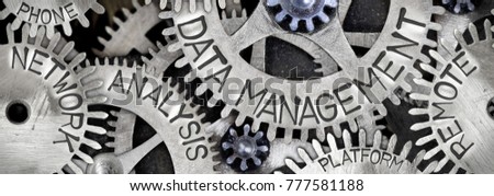 Macro photo of tooth wheel mechanism with DATA MANAGEMENT concept related words imprinted on metal surface