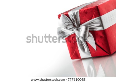 Christmas valentine or birthday red gift box with silver ribbon.