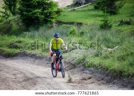 man rides the bicycle up in the mountains