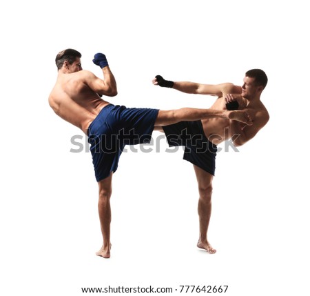Attractive young kickboxers fighting on white background