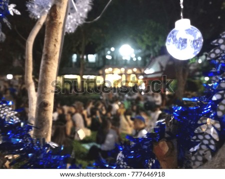 Christmas market blur background with light decoration, kiosk, shop and crowd