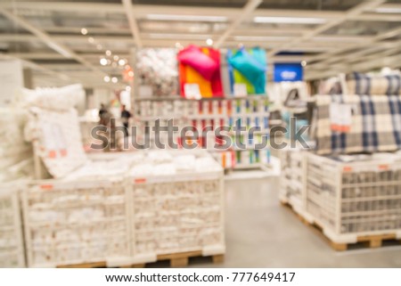 blur picture background  of pillow and bedroom section display showroom in furniture mall
