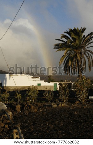 Morning rainbow on the village