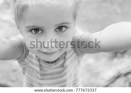 Cute little girl making selfie, black and white photo