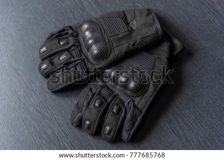 
Gloves for motorcyclists on a gray wooden background