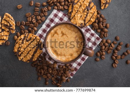Hot coffee cup with chocolate cookies on stone table. top view with copyspace