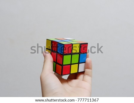The hand that catches rubik.Rubik's unfinished.It is used to practice brain skills and competition.When you feel bored and stressed, you can play rubik. Royalty-Free Stock Photo #777711367