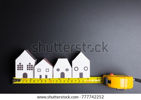 White house toy and construction tools on black background with copy space.Real estate concept, New house concept, Finance loan business concept, Repair maintenance concept Royalty-Free Stock Photo #777742252