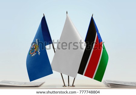 Flags of Melilla and South Sudan with a white flag in the middle