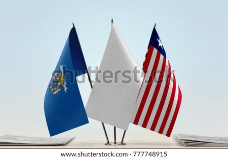 Flags of Melilla and Liberia with a white flag in the middle