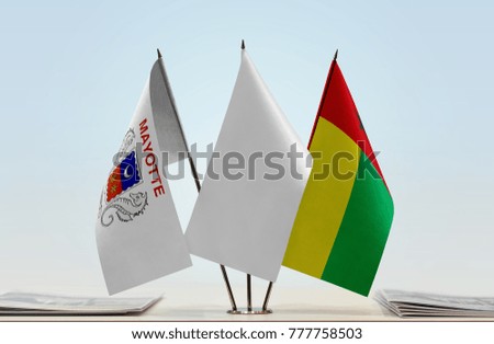 Flags of Mayotte and Guinea-Bissau with a white flag in the middle