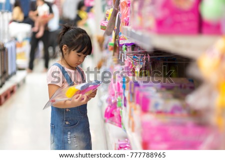 Asian girls shop for toys at department stores Royalty-Free Stock Photo #777788965