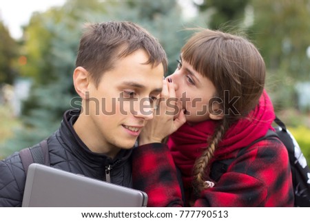 Shocking secrets girls whispering to boy and smiles