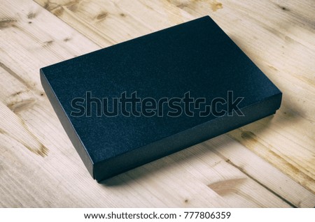 Black box mock up on wooden background