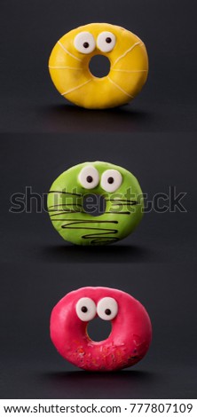 colorful glazed donuts with funny eyes on a black background
