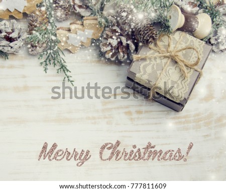 Christmas gift box, decor and fir tree branch on wooden table. Top view with copy space