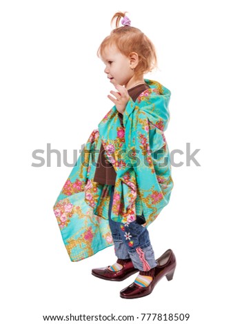 Funny little girl wearing mother's shoes isolated on white