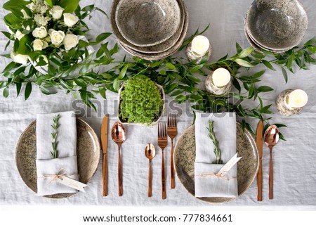 Holiday table setting with Linen napkins and rose gold cutlery. Close up Royalty-Free Stock Photo #777834661