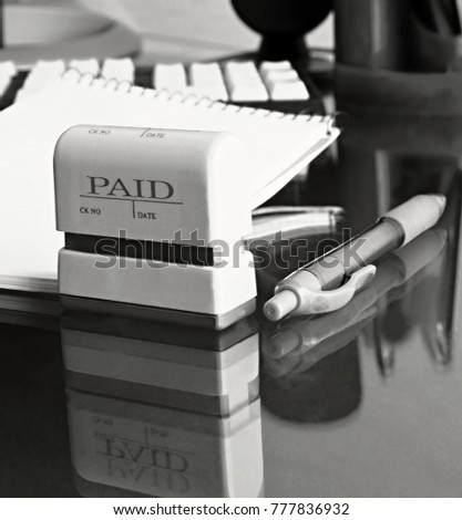 paid stamp saying paid on a office table stock photo